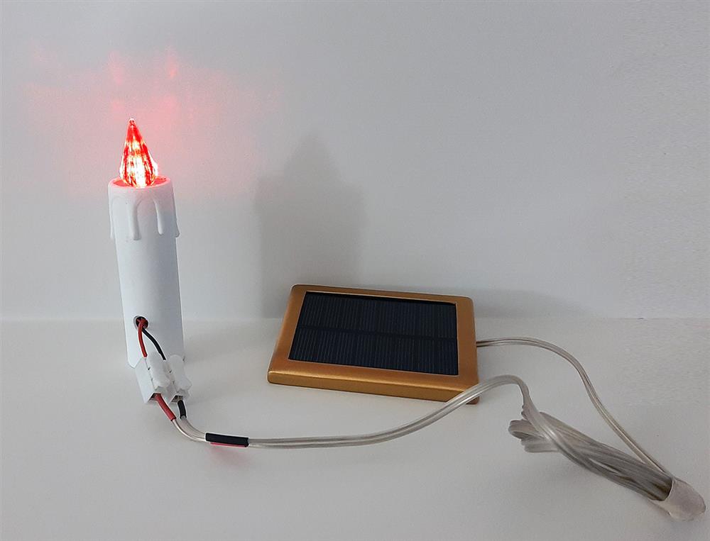 Votive light with solar panel